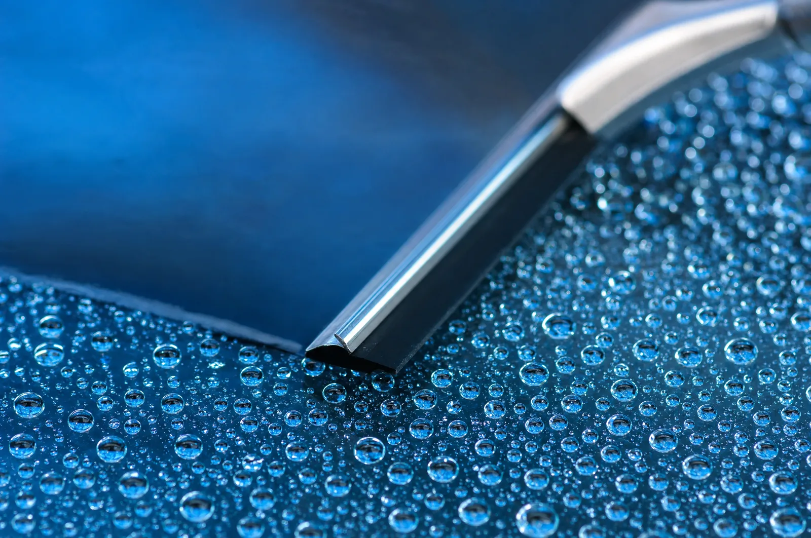 Water beads on clean glass, each one catching the light
